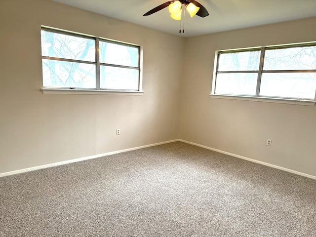 empty room with ceiling fan and carpet floors