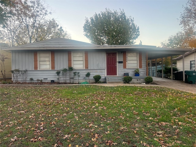 view of front of property with a front yard and a carport