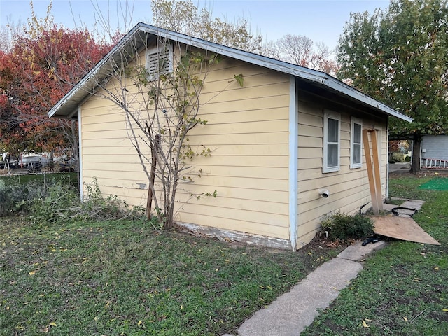 view of side of property with a lawn