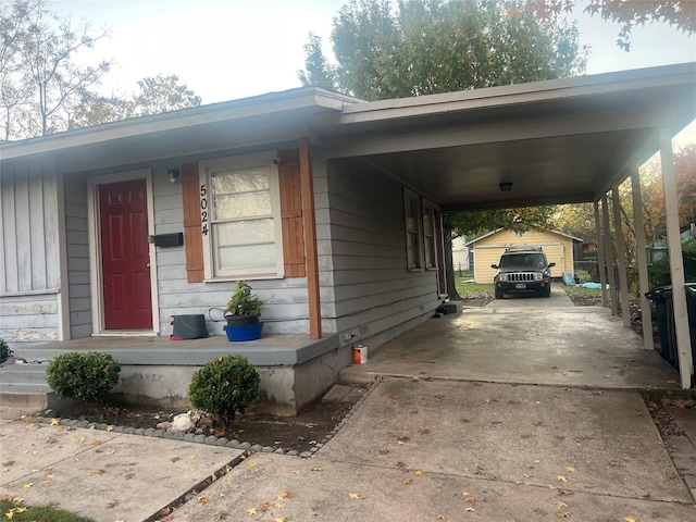 view of front of home with a carport, an outdoor structure, and a garage