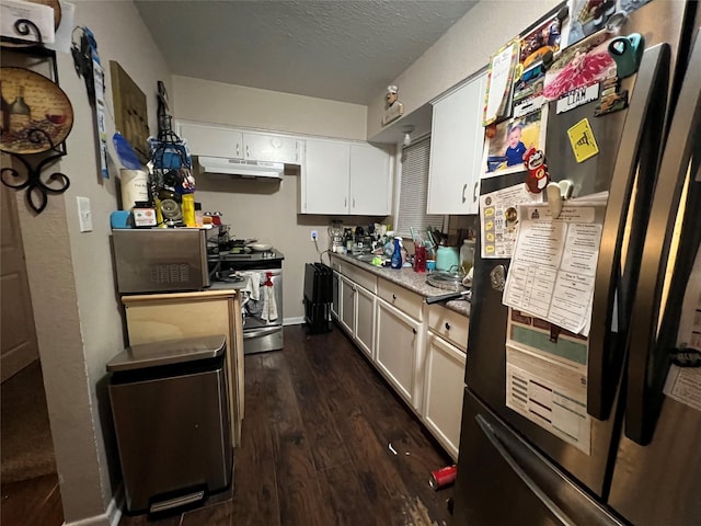 kitchen with stainless steel stove, white cabinetry, dark hardwood / wood-style floors, a textured ceiling, and black fridge