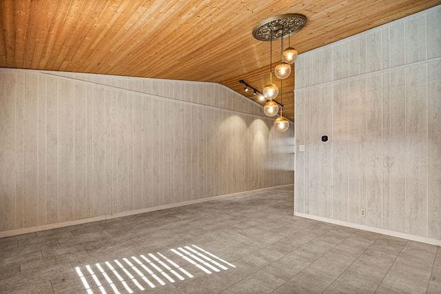 spare room featuring wooden walls, vaulted ceiling, and wooden ceiling