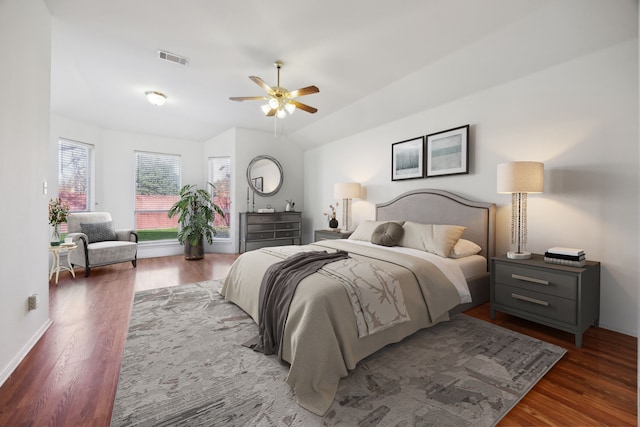 bedroom with vaulted ceiling, ceiling fan, and dark wood-type flooring