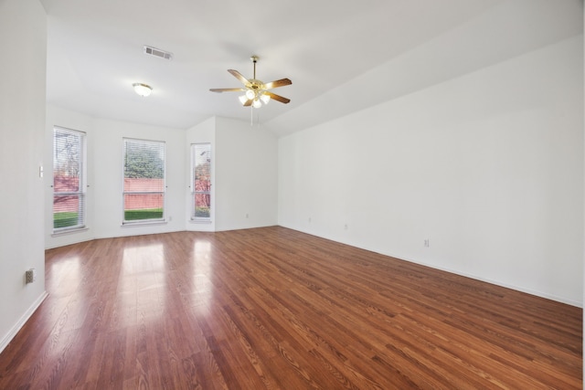 unfurnished room with dark hardwood / wood-style floors, ceiling fan, and vaulted ceiling