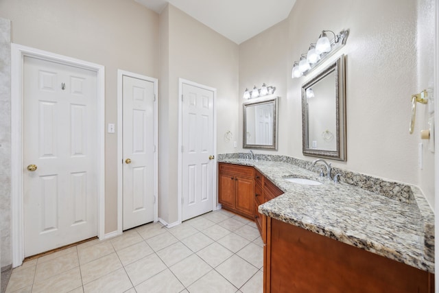 bathroom with tile patterned flooring and vanity