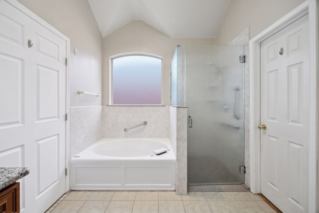 bathroom with tile patterned floors, vanity, shower with separate bathtub, and vaulted ceiling