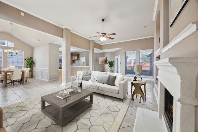 living room with vaulted ceiling, crown molding, light tile patterned floors, and ceiling fan with notable chandelier