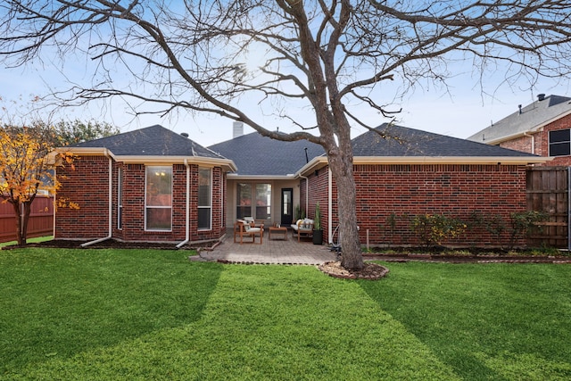 rear view of property with a lawn and a patio