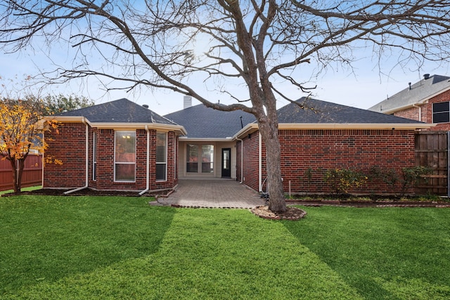 rear view of house featuring a patio area and a lawn