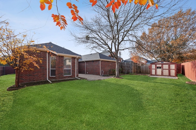 view of yard with a storage shed and a patio