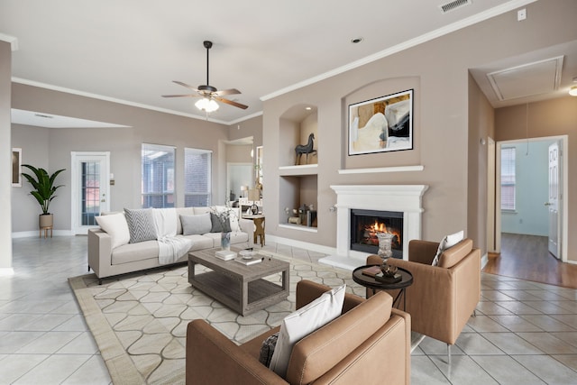 living room with ceiling fan, built in features, light tile patterned floors, and ornamental molding