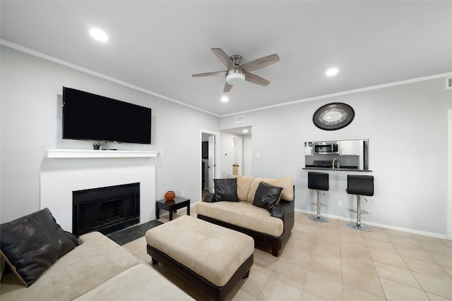 living room featuring light tile patterned floors, ceiling fan, and crown molding