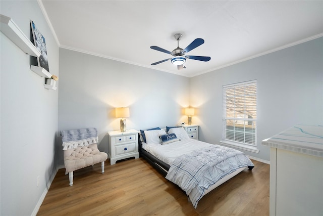 bedroom featuring ceiling fan, light wood-type flooring, and ornamental molding