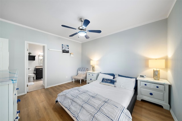 bedroom with ensuite bathroom, ceiling fan, wood-type flooring, and ornamental molding