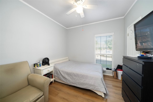 bedroom with ceiling fan, light hardwood / wood-style floors, and ornamental molding