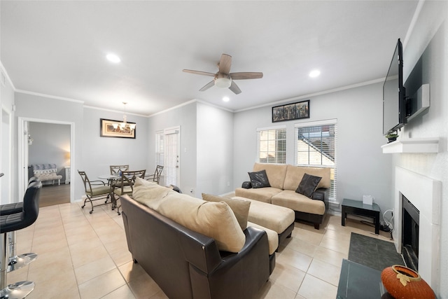 tiled living room featuring ceiling fan with notable chandelier and ornamental molding