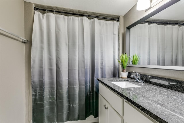 bathroom with vanity and curtained shower