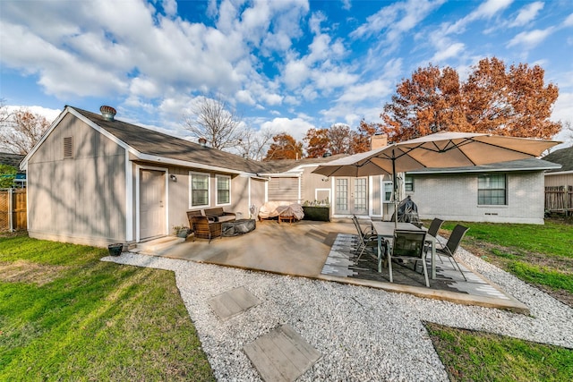 rear view of house featuring french doors, a yard, and a patio area