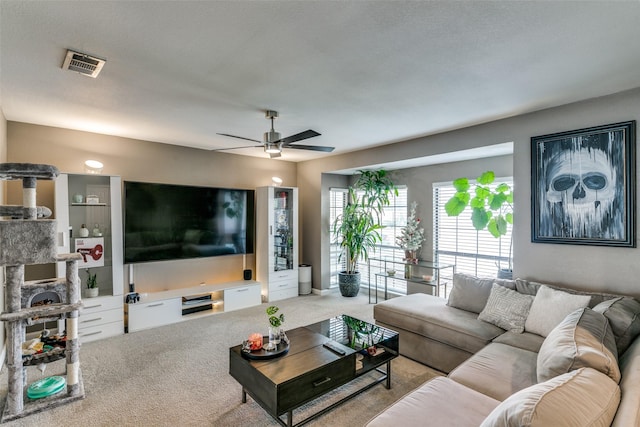 living room with ceiling fan and light colored carpet