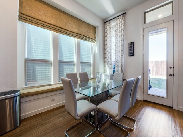 dining area featuring dark hardwood / wood-style flooring and a healthy amount of sunlight