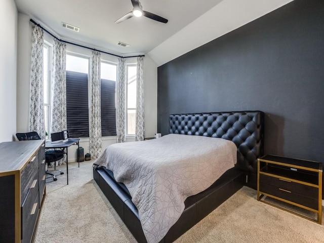 bedroom with vaulted ceiling, light colored carpet, and ceiling fan