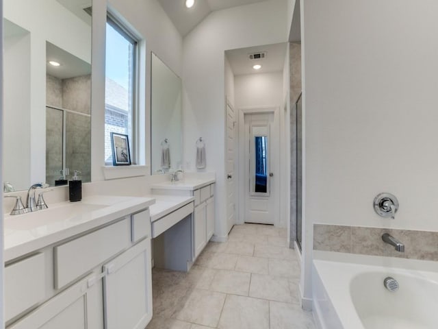 bathroom featuring tile patterned floors, vanity, and shower with separate bathtub