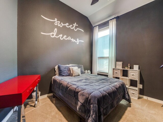 carpeted bedroom with lofted ceiling and ceiling fan