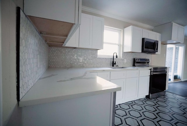 kitchen featuring crown molding, sink, range with electric cooktop, tasteful backsplash, and white cabinetry