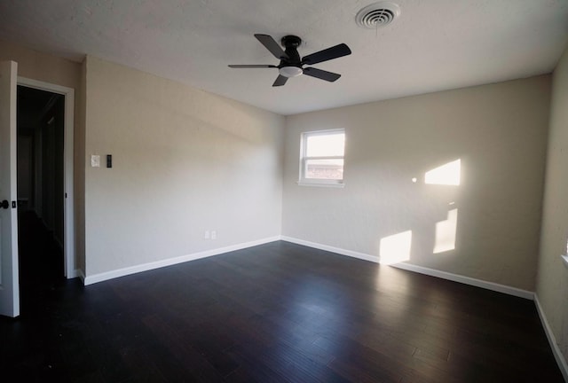 empty room featuring dark hardwood / wood-style flooring and ceiling fan