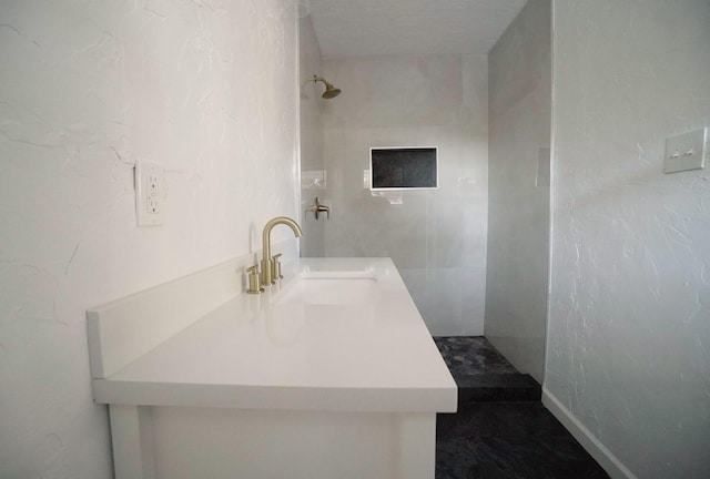 bathroom with a shower and vanity