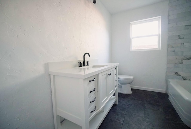 bathroom featuring vanity, toilet, and a tub to relax in