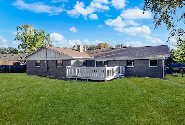 back of house featuring a yard and a wooden deck