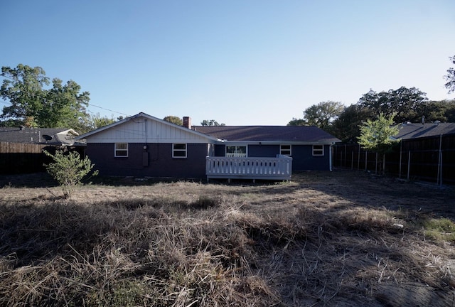 rear view of property featuring a deck