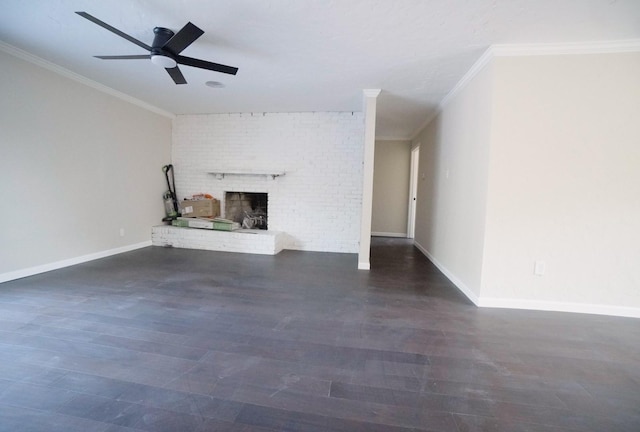 unfurnished living room featuring ceiling fan, dark hardwood / wood-style floors, crown molding, and a brick fireplace