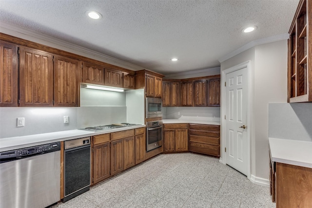 kitchen with crown molding, stainless steel appliances, and a textured ceiling