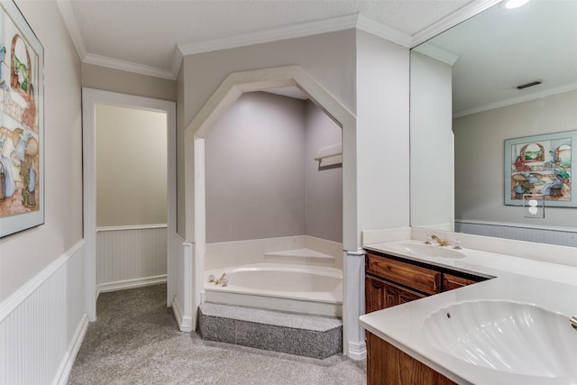 bathroom featuring crown molding, a bathtub, and vanity