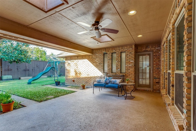 view of patio / terrace featuring an outdoor living space, ceiling fan, and a playground