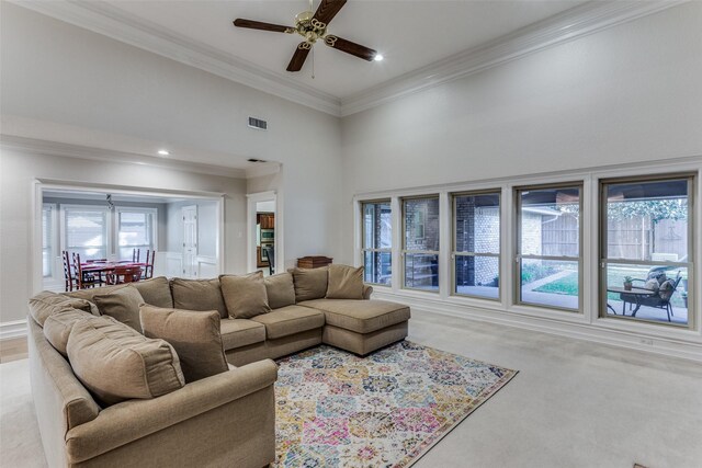 living room featuring ceiling fan and crown molding