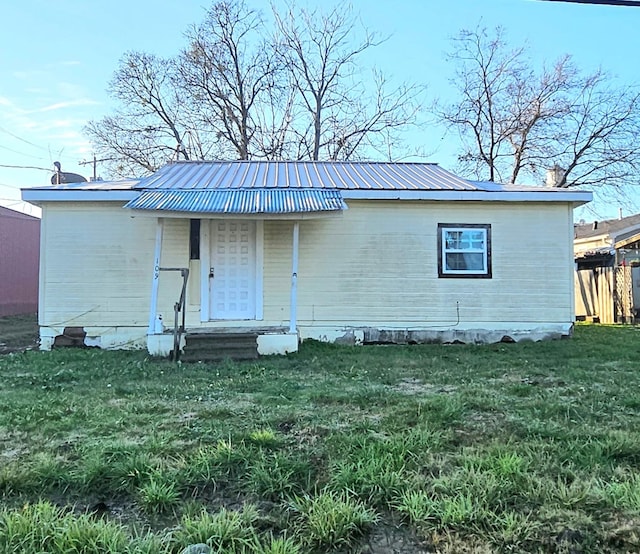 rear view of property with a yard