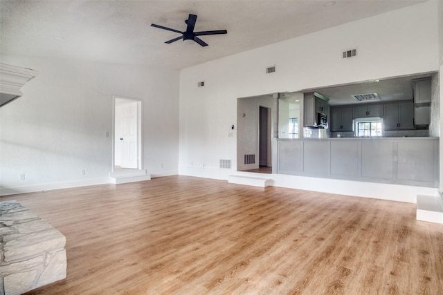 unfurnished living room with hardwood / wood-style flooring and ceiling fan