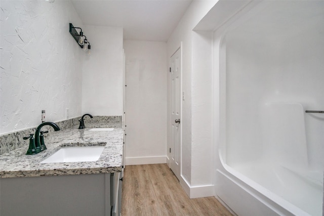 bathroom with vanity and hardwood / wood-style flooring