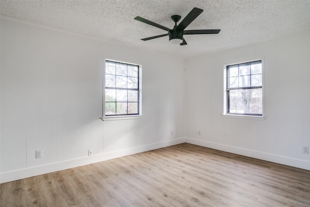 unfurnished room featuring ceiling fan, plenty of natural light, a textured ceiling, and light hardwood / wood-style flooring