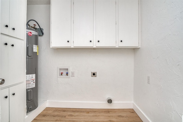 laundry room featuring electric dryer hookup, cabinets, electric water heater, hookup for a washing machine, and light hardwood / wood-style floors