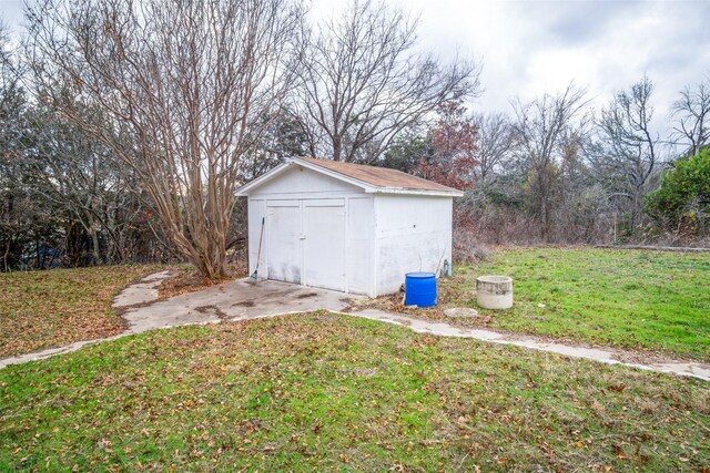 view of outdoor structure featuring a lawn