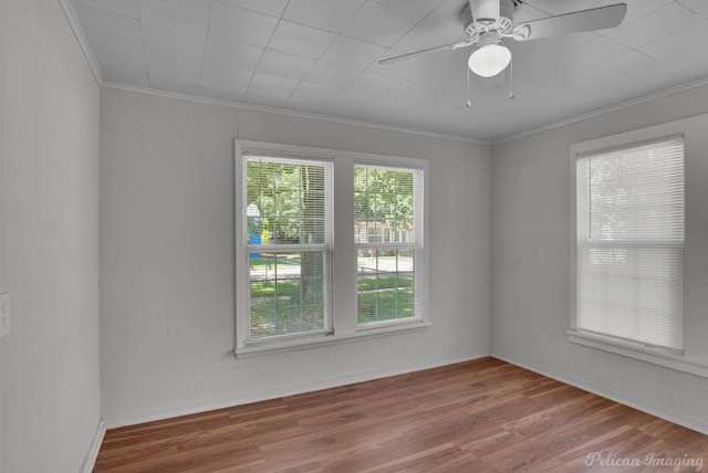 unfurnished room with hardwood / wood-style flooring, ornamental molding, and ceiling fan