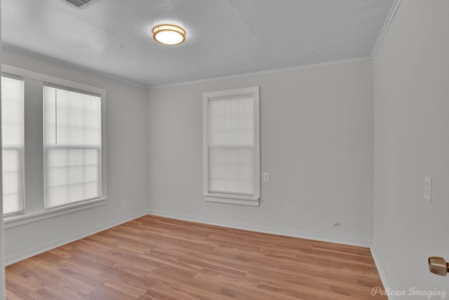 spare room with crown molding and light hardwood / wood-style floors