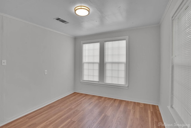 empty room featuring ornamental molding and light hardwood / wood-style floors