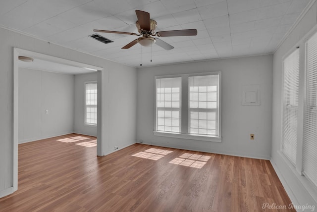 unfurnished room with light wood-type flooring, ceiling fan, and ornamental molding