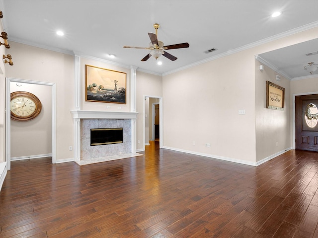 unfurnished living room with ceiling fan, dark hardwood / wood-style flooring, crown molding, and a high end fireplace