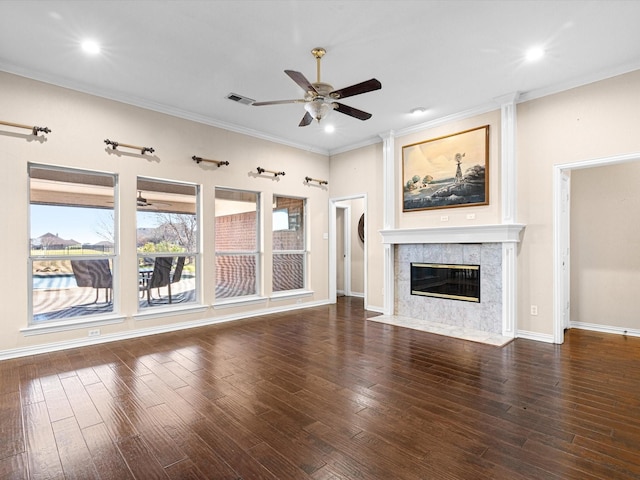 unfurnished living room with ceiling fan, dark hardwood / wood-style flooring, crown molding, and a tile fireplace